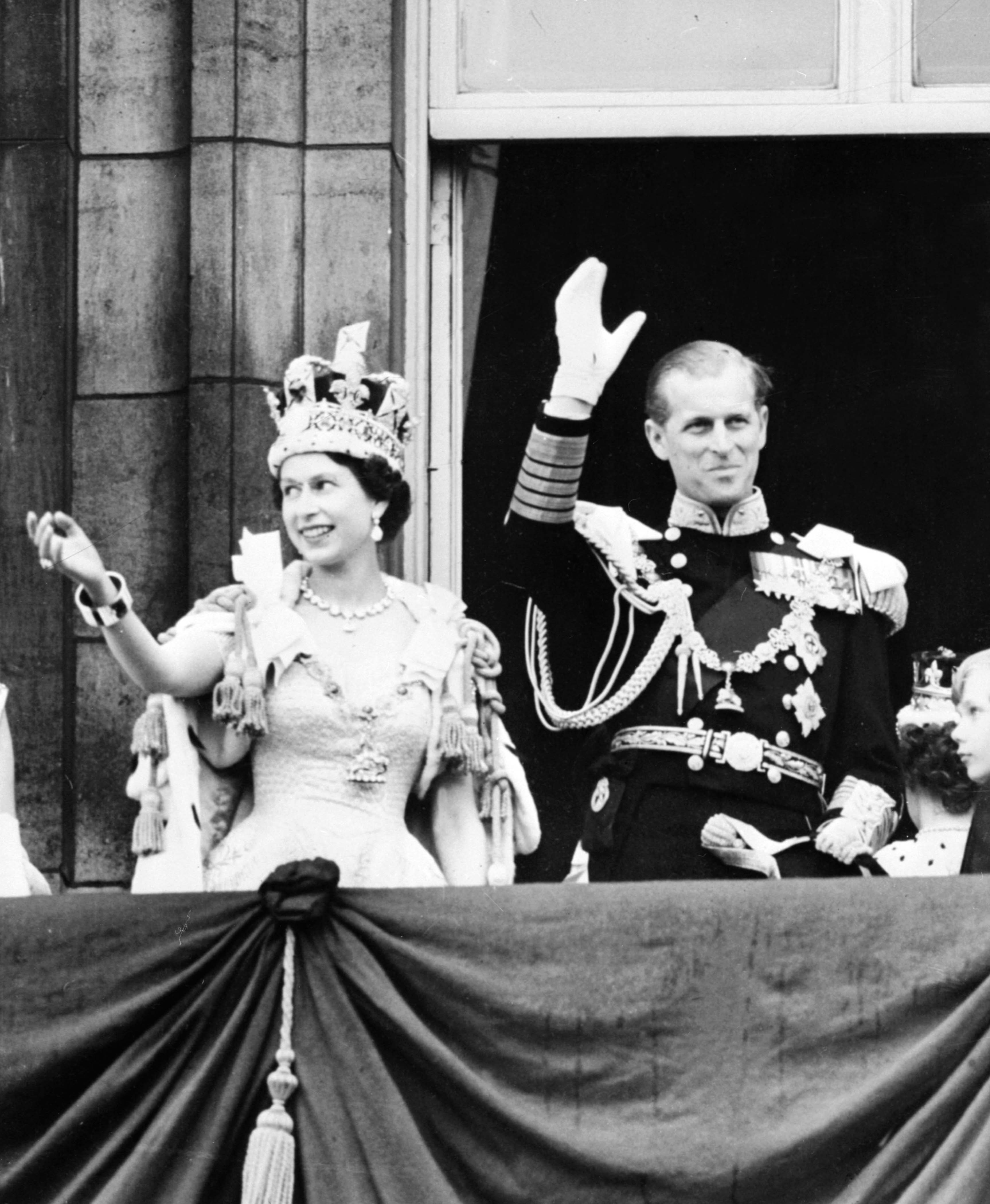 (FILES) In this file picture taken on June 2, 1953 Britain's Queen Elizabeth II and by Prince Philip, The Duke of Edinburgh wave to the crowds from the balcony at Buckingham Palace following the Coronation ceremony in London. Queen Elizabeth II marked the 60th anniversary of her coronation on June 4, 2013 with a service at Westminster Abbey filled with references to the rainy day in 1953 when she was crowned. AFP PHOTO/FILES