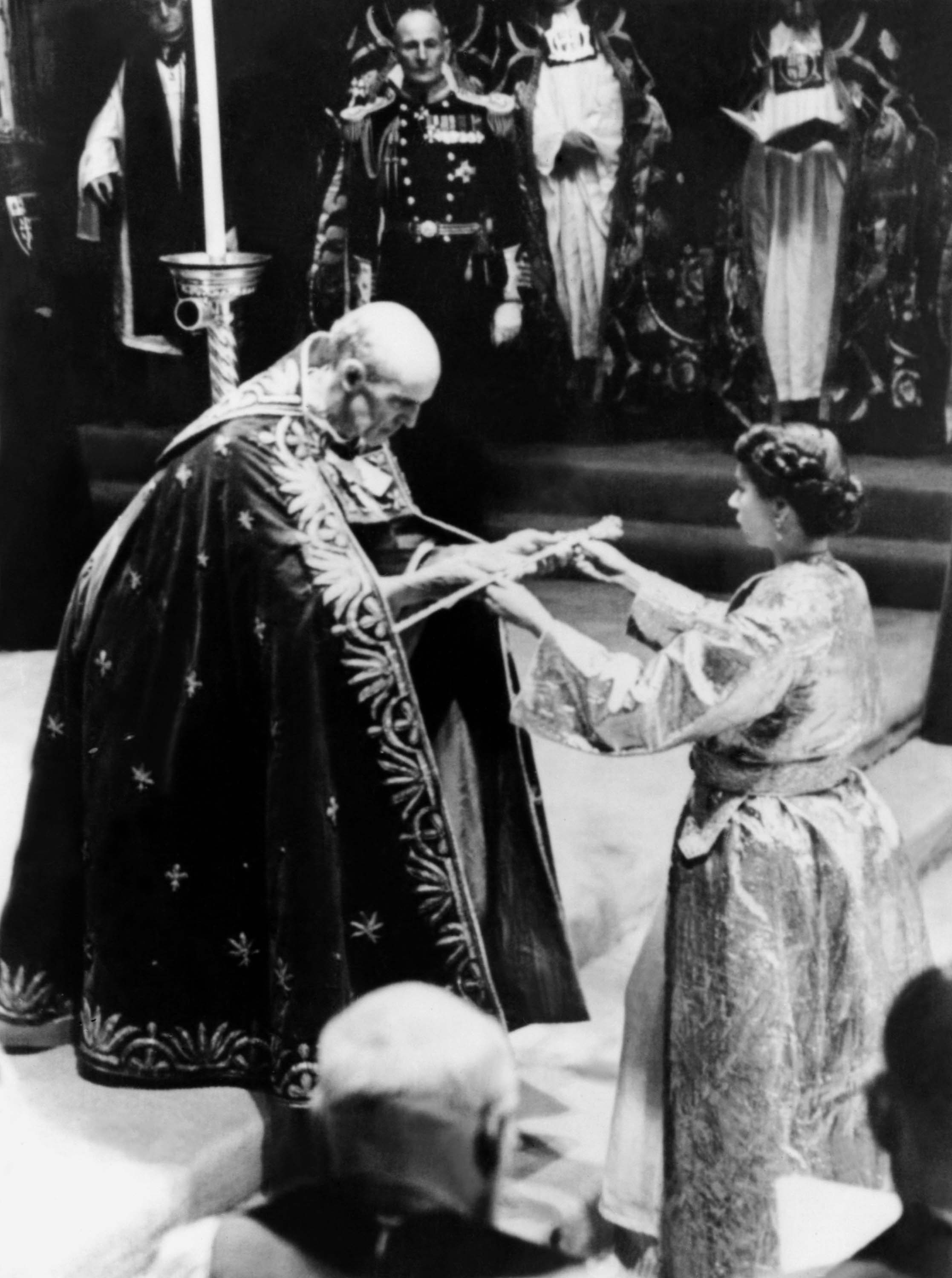 (FILES) In this file picture taken on June 2, 1953 The then Archbishop of Canterbury Geoffrey Fisher presents Britain's Queen Elizabeth II with a sword, prior to the Coronation ceremony in London. Queen Elizabeth II marked the 60th anniversary of her coronation on June 4, 2013 with a service at Westminster Abbey filled with references to the rainy day in 1953 when she was crowned. AFP PHOTO/FILES