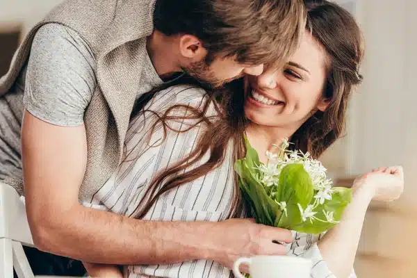 Depositphotos_156649708-Stock-Photo-Young-Couple-Embracing-With-Bouquet 2025 word2