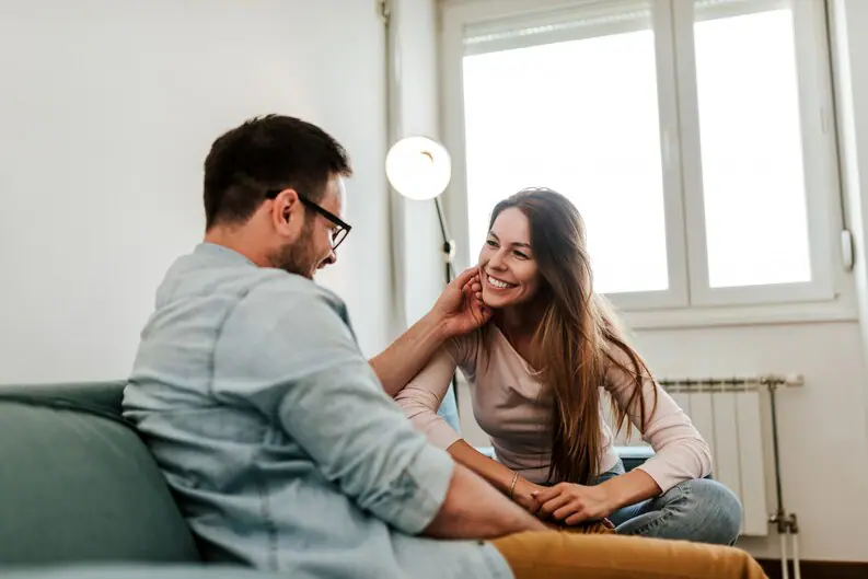 Young-Affectionate-Couple-Talking-While-Sitting-Sofa-Medium-Jpg 2025 word2