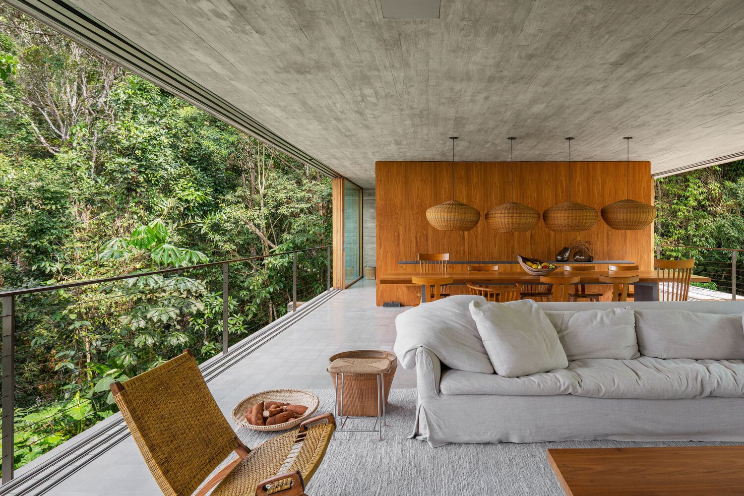 Ambientes sociais da Casa Azul, revelando a vista para a mata atlântica ao redor.