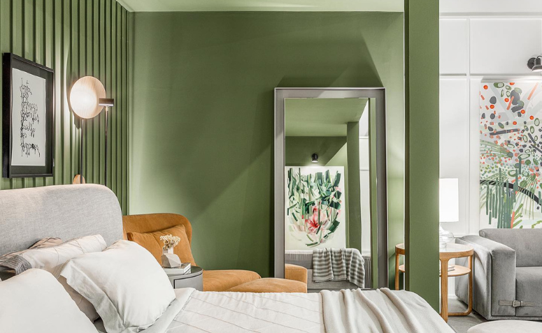 quarto com decoração em verde-oliva, mostrando como usar cores que acalmam para criar um ambiente acolhedor e natural