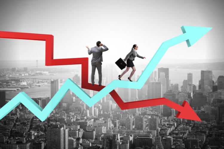 Crise-Em-Oportunidade-3 Dois profissionais equilibram-se em gráficos flutuantes acima de uma cidade. A mulher avança em uma seta azul ascendente, enquanto o homem hesita na seta vermelha descendente, simbolizando a visão estratégica para transformar crise em oportunidade e alcançar o sucesso.