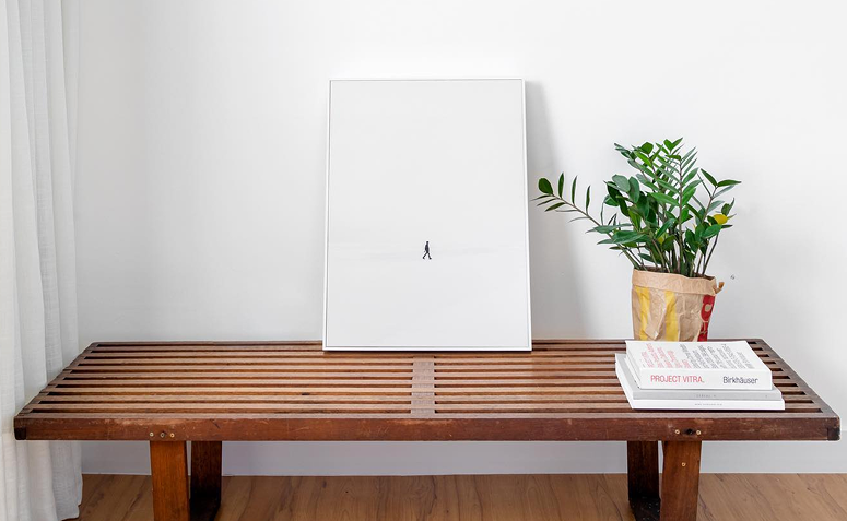 zamioculca em vaso sobre banco de madeira decorando casa minimalista