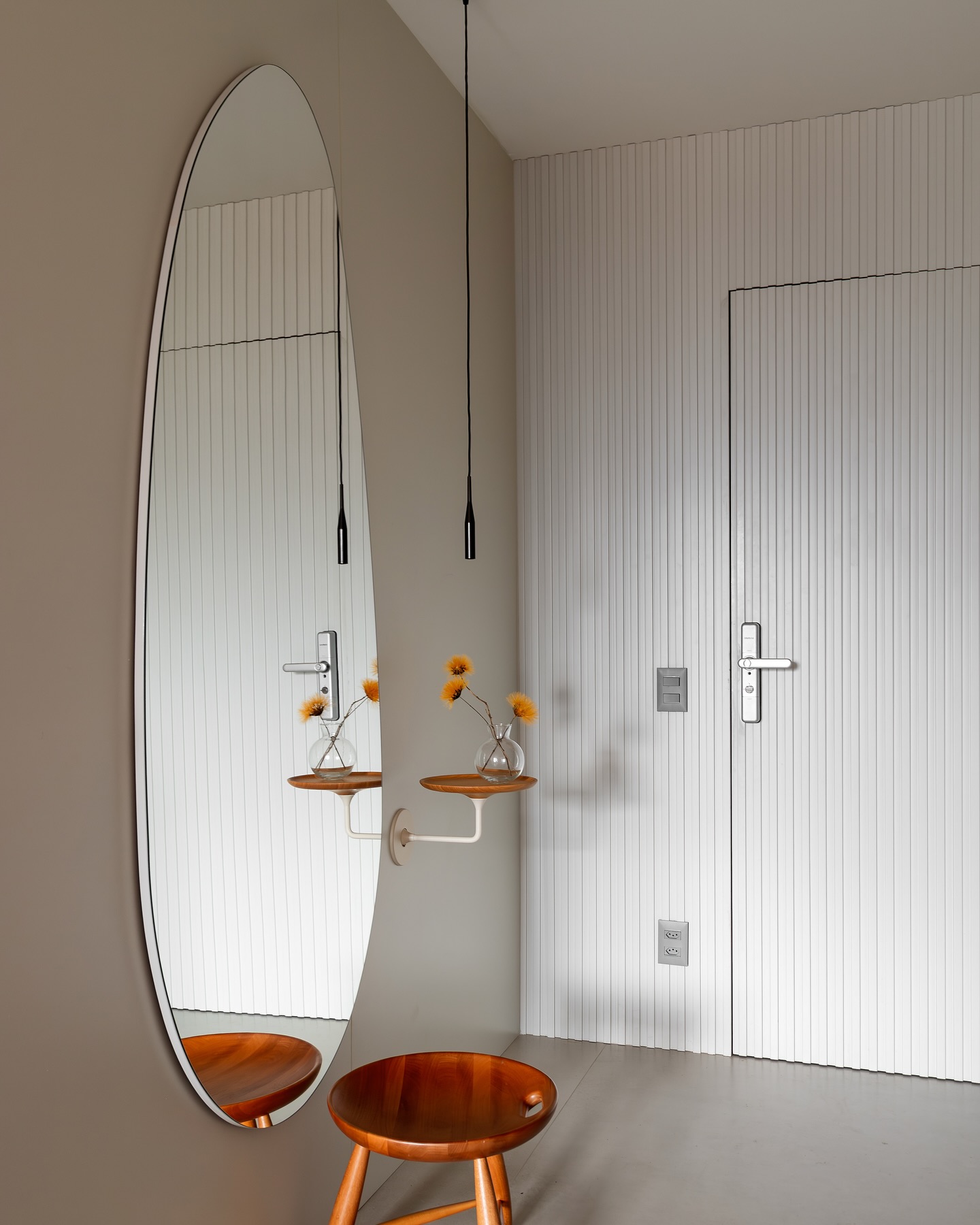 Espelho com formato orgânico aplicado no corredor.