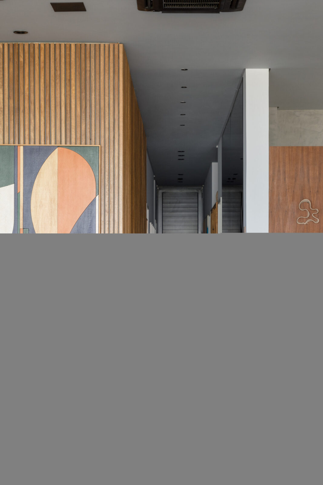 Espelho no corredor usado como painel para ampliar o espaço.