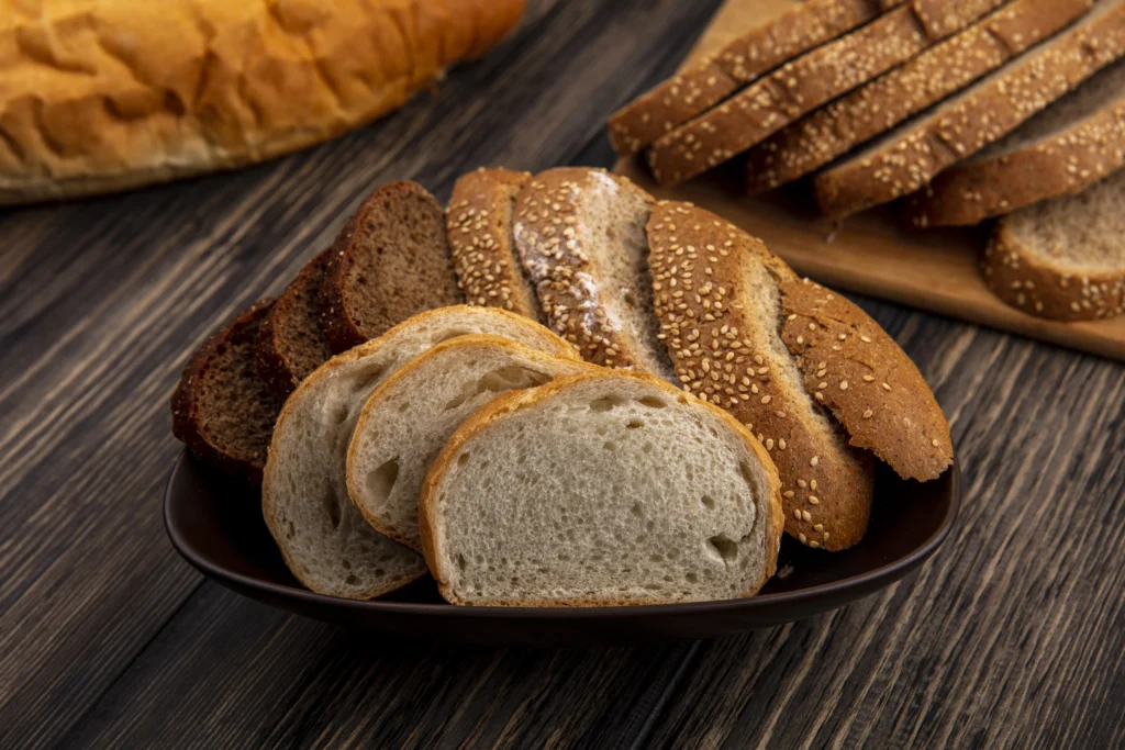 side-view-breads-as-sliced-seeded-brown-cob-rye-white-ones-bowl-cutting-board-wooden-background-1024x683-1 2026